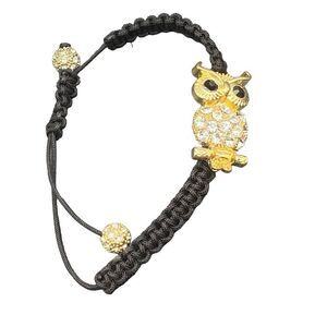 Gold rhinestone owl bracelet on black adjustable macramé